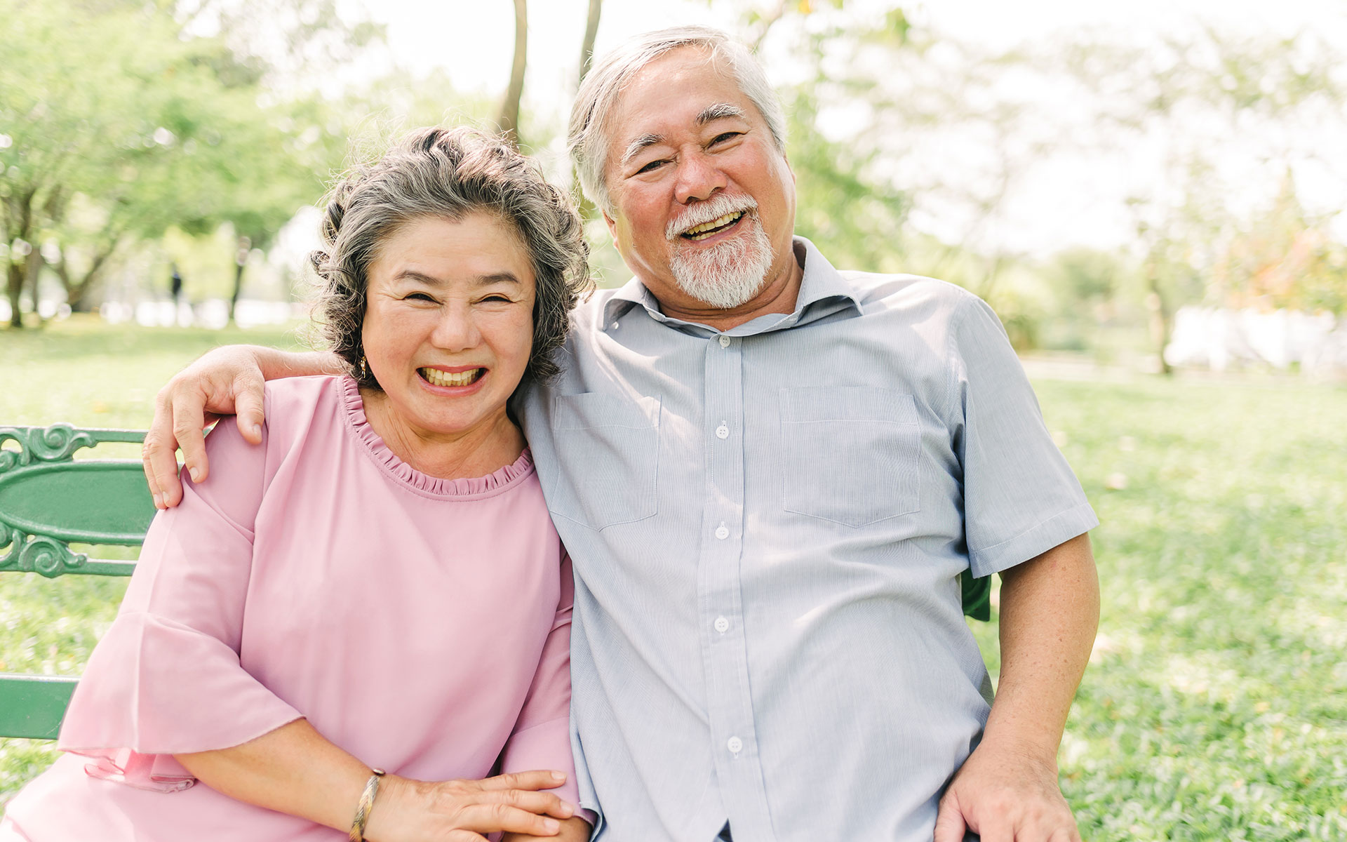 happy asian senior couple laughing smiling while sitting park